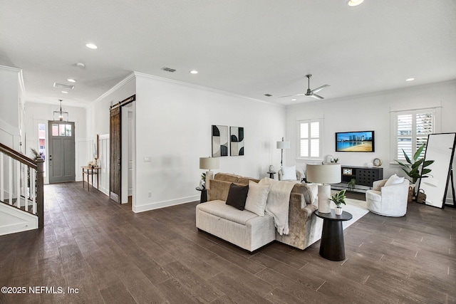 living area with visible vents, ceiling fan, dark wood finished floors, stairs, and a barn door