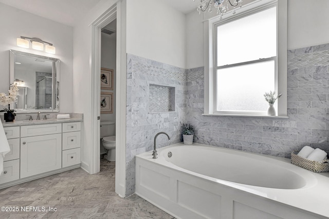 bathroom featuring a shower with door, toilet, a bath, and vanity