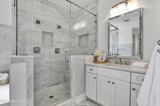 bathroom with vanity, visible vents, a shower stall, a notable chandelier, and marble finish floor