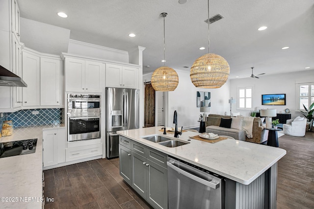 kitchen featuring visible vents, gray cabinets, a sink, white cabinets, and appliances with stainless steel finishes