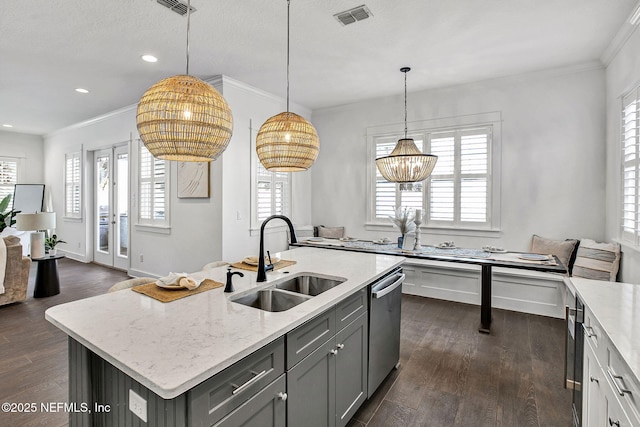 kitchen featuring dark wood-type flooring, gray cabinetry, ornamental molding, a sink, and dishwasher