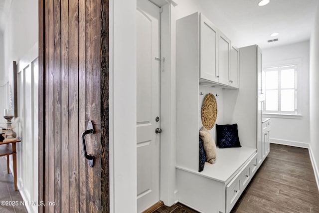 mudroom with recessed lighting, visible vents, baseboards, and wood finished floors