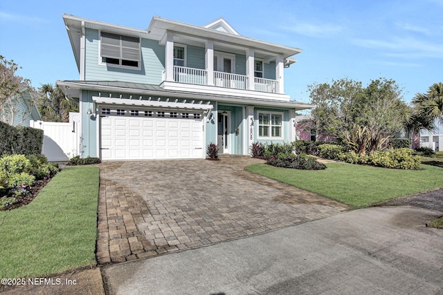 view of front of house featuring a front yard, a standing seam roof, a garage, decorative driveway, and metal roof