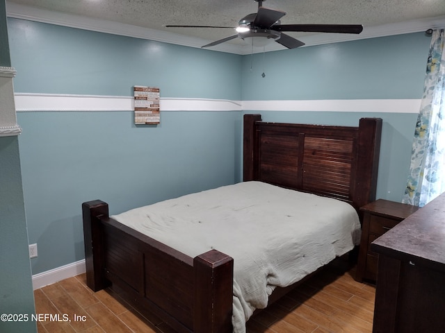 bedroom with wood finish floors, a textured ceiling, ceiling fan, and ornamental molding