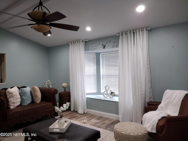 living room featuring recessed lighting, a ceiling fan, and wood finished floors