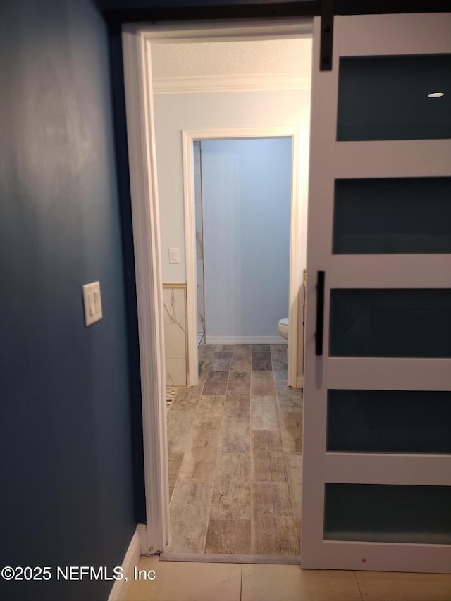 hall featuring crown molding and wood finished floors