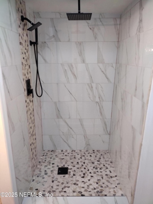 bathroom with visible vents and a shower stall