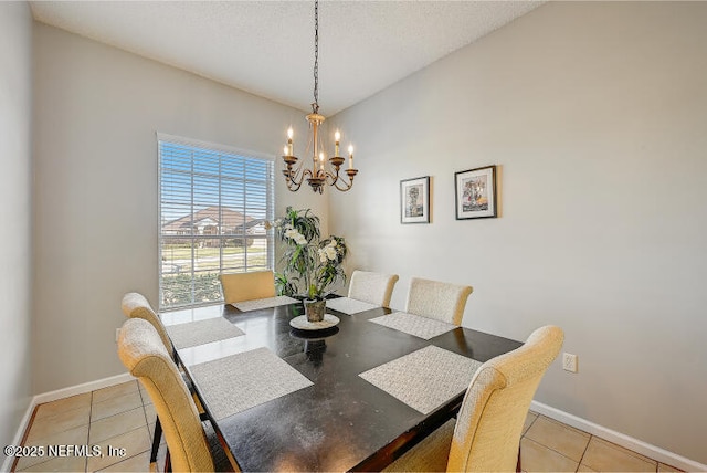 dining room with light tile patterned floors, baseboards, and a chandelier