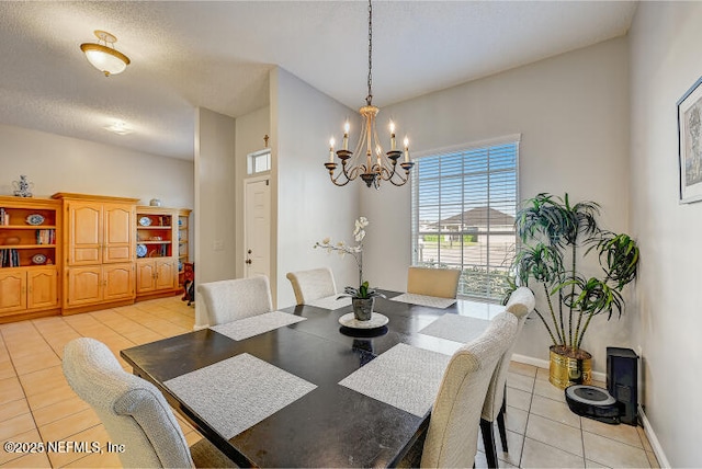 dining room featuring light tile patterned floors, baseboards, and a chandelier