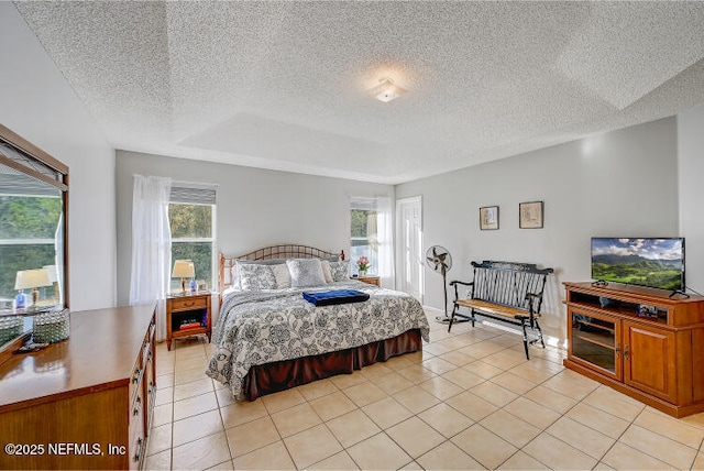 bedroom with light tile patterned floors and a textured ceiling