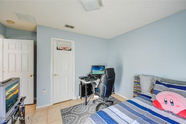 bedroom featuring light tile patterned floors, visible vents, and baseboards