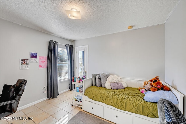 bedroom featuring light tile patterned flooring and a textured ceiling