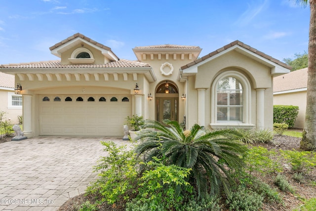3 Village View Way, Palm Coast, FL 32137 - mediterranean / spanish-style home featuring a tiled roof, decorative driveway, an attached garage, and stucco siding