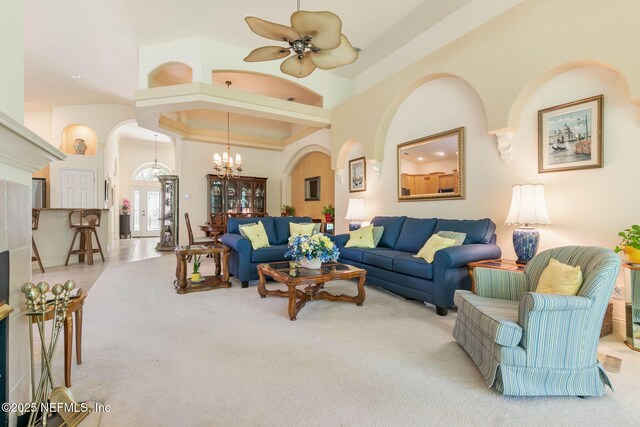 3 Village View Way, Palm Coast, FL 32137 - living area with arched walkways, ceiling fan with notable chandelier, a towering ceiling, and carpet floors