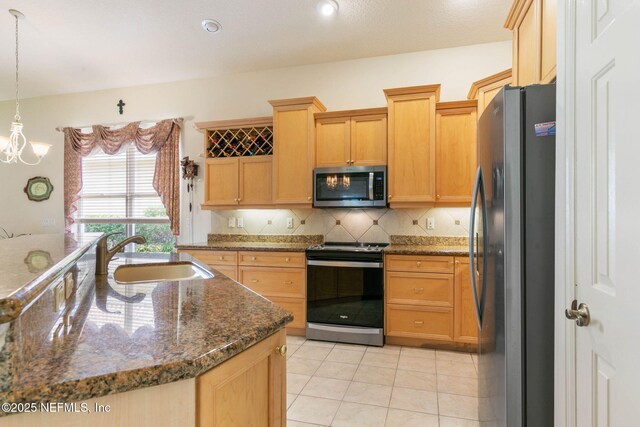 3 Village View Way, Palm Coast, FL 32137 - kitchen with light tile patterned floors, dark stone counters, a sink, decorative backsplash, and stainless steel appliances