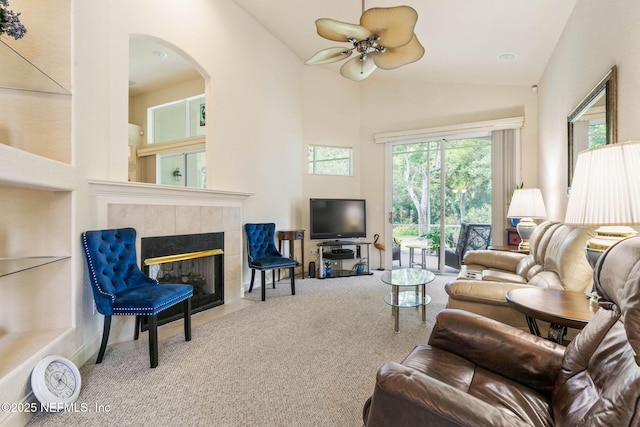 3 Village View Way, Palm Coast, FL 32137 - living area featuring a ceiling fan, carpet floors, high vaulted ceiling, arched walkways, and a tiled fireplace