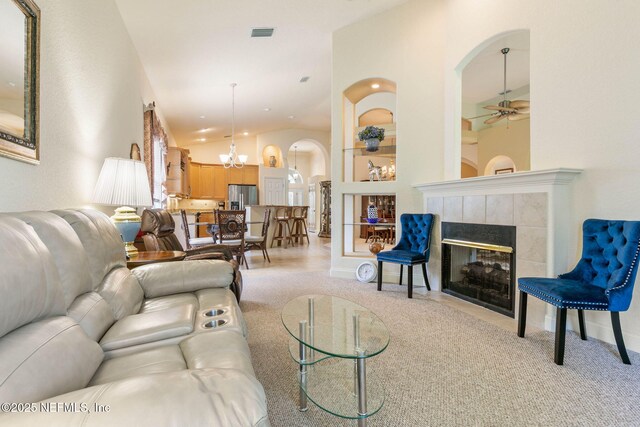3 Village View Way, Palm Coast, FL 32137 - living area with light colored carpet, visible vents, ceiling fan with notable chandelier, and arched walkways