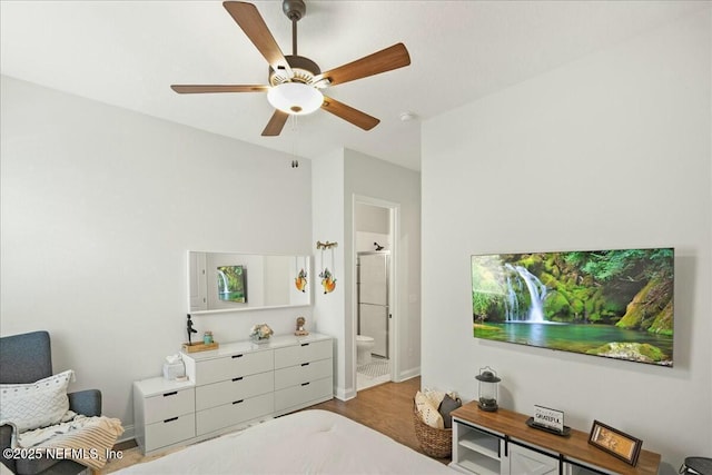 bedroom featuring ceiling fan, light wood-type flooring, baseboards, and connected bathroom