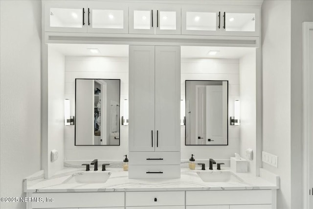 bathroom featuring double vanity and a sink