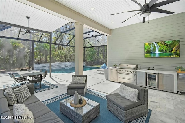 view of patio / terrace with ceiling fan, an outdoor kitchen, wine cooler, outdoor lounge area, and a lanai