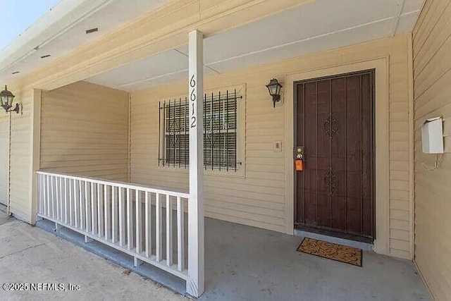 property entrance with covered porch