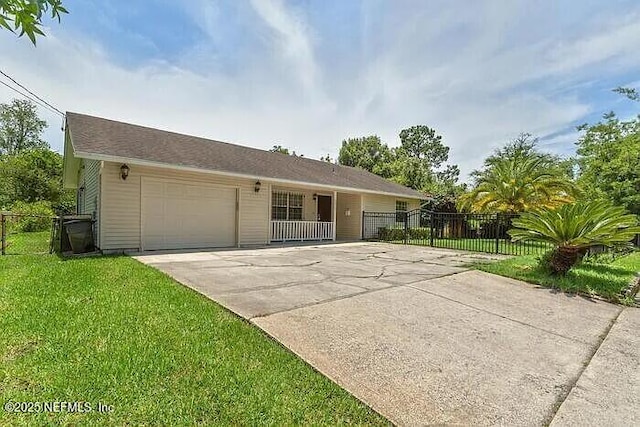 ranch-style home featuring a garage, concrete driveway, a front lawn, and fence