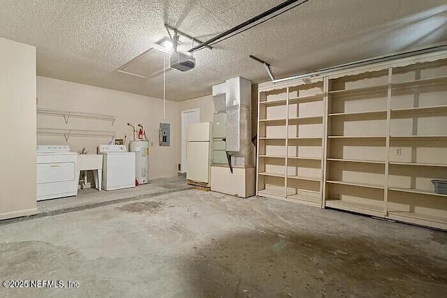 garage with washing machine and dryer, water heater, electric panel, a garage door opener, and freestanding refrigerator