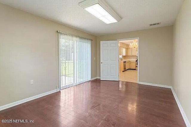 empty room with a wealth of natural light, visible vents, and baseboards