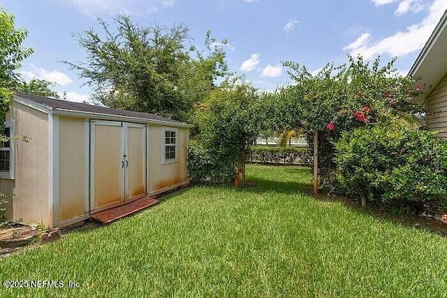 view of yard with an outbuilding and a shed