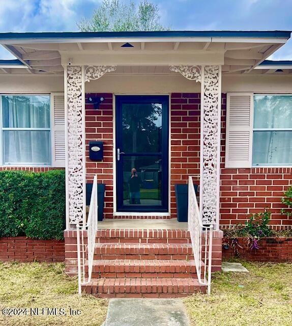 entrance to property with brick siding