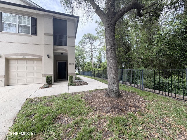 12301 Kernan Forest Blvd Unit 1206, Jacksonville, FL 32225 - view of yard featuring fence, an attached garage, and driveway