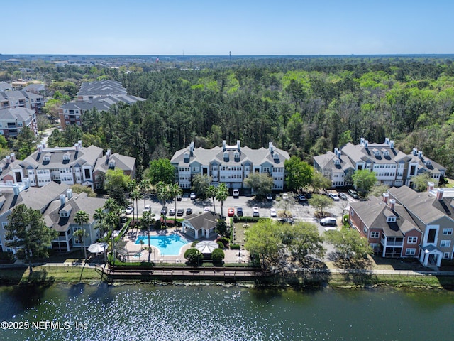 bird's eye view with a residential view, a wooded view, and a water view