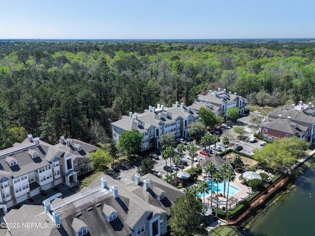 birds eye view of property featuring a wooded view and a residential view