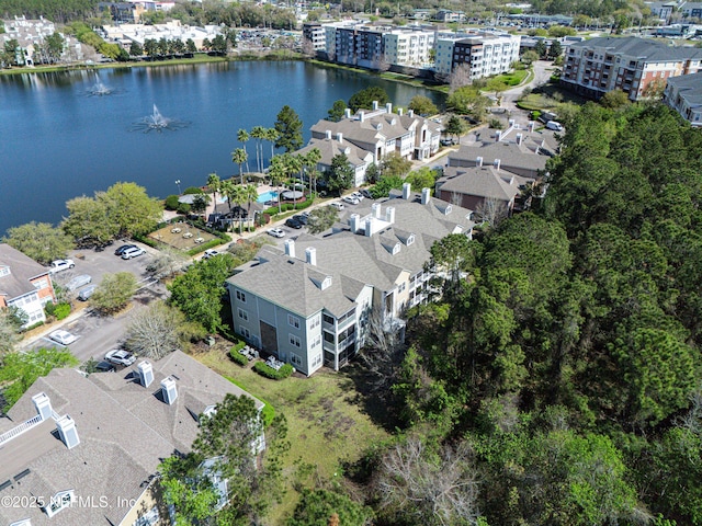 drone / aerial view with a residential view and a water view