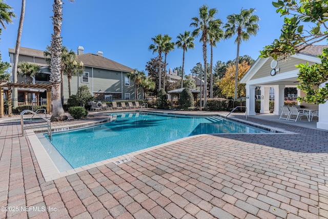 pool featuring a patio and fence