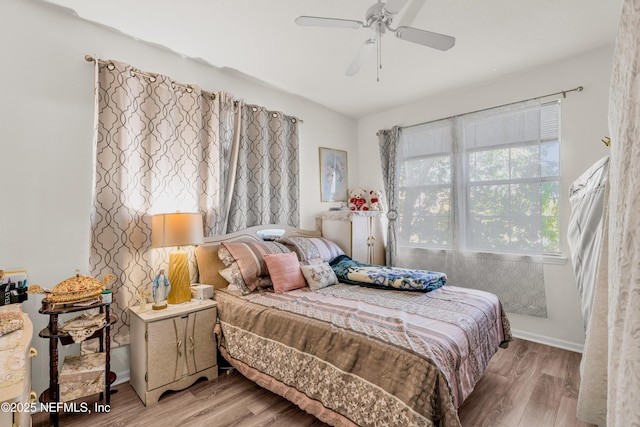 bedroom with a ceiling fan and light wood-type flooring