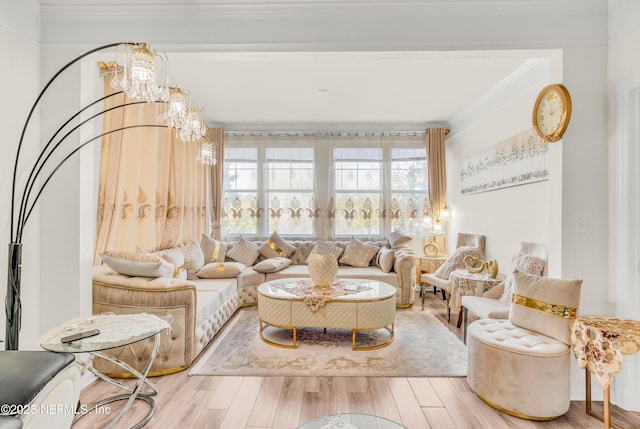 living area with a notable chandelier, crown molding, and wood finished floors