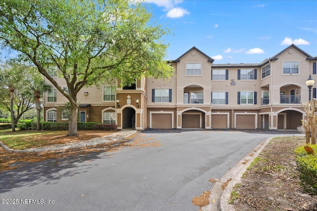 10961 Burnt Mill Rd Unit 1135, Jacksonville, FL 32256 - townhome / multi-family property with driveway, stucco siding, and an attached garage