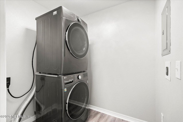 10961 Burnt Mill Rd Unit 1135, Jacksonville, FL 32256 - washroom with baseboards, electric panel, stacked washer / dryer, laundry area, and wood finished floors