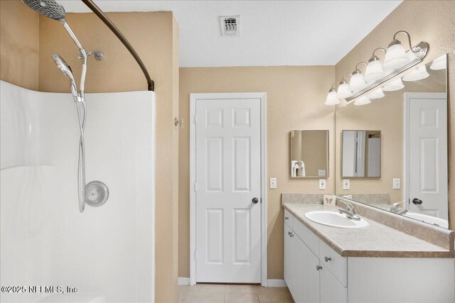 10961 Burnt Mill Rd Unit 1135, Jacksonville, FL 32256 - full bathroom featuring visible vents, baseboards, a shower, vanity, and tile patterned flooring