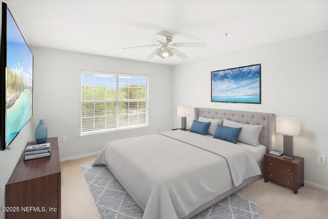 10961 Burnt Mill Rd Unit 1135, Jacksonville, FL 32256 - bedroom featuring baseboards, a ceiling fan, and light colored carpet