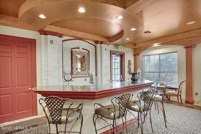 10961 Burnt Mill Rd Unit 1135, Jacksonville, FL 32256 - kitchen with visible vents, recessed lighting, decorative columns, and a kitchen bar