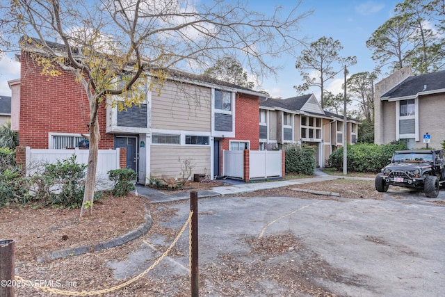 8880 Old Kings Rd S Unit 84, Jacksonville, FL 32257 - view of property featuring brick siding, a residential view, and fence