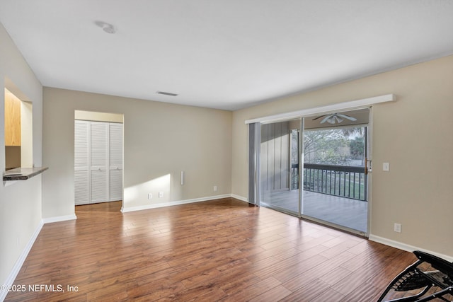 8880 Old Kings Rd S Unit 84, Jacksonville, FL 32257 - unfurnished living room with baseboards and wood finished floors