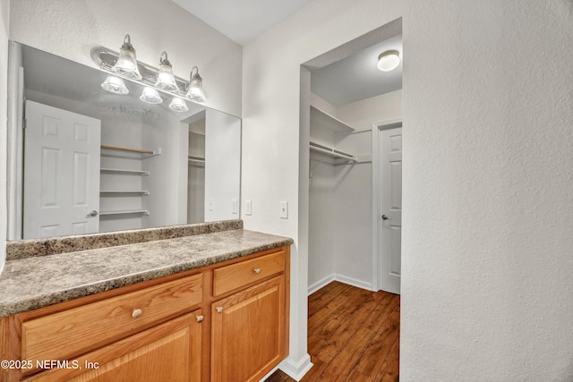 8880 Old Kings Rd S Unit 84, Jacksonville, FL 32257 - bathroom with vanity, a walk in closet, and wood finished floors