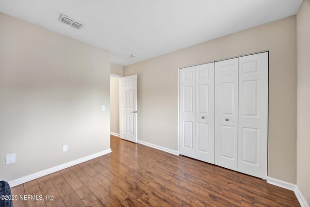 8880 Old Kings Rd S Unit 84, Jacksonville, FL 32257 - unfurnished bedroom featuring wood finished floors, visible vents, a closet, and baseboards