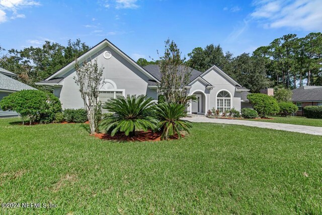 2619 Wrightson Dr, Jacksonville, FL 32223 - ranch-style home featuring driveway, a front yard, and stucco siding