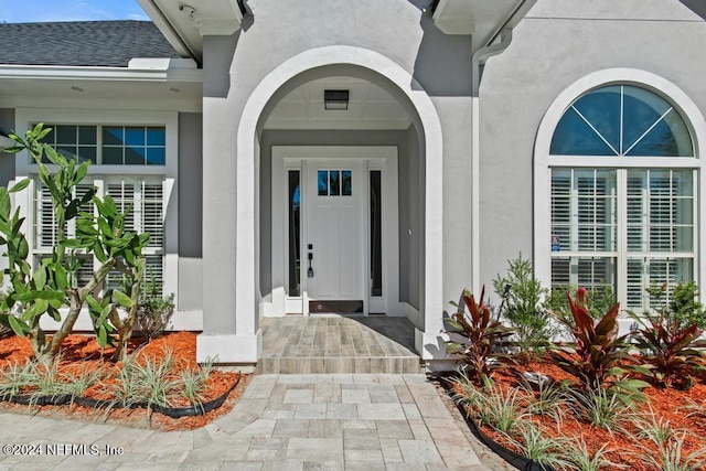 2619 Wrightson Dr, Jacksonville, FL 32223 - property entrance featuring stucco siding and a shingled roof