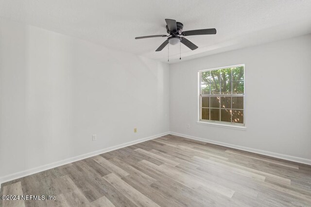 2619 Wrightson Dr, Jacksonville, FL 32223 - empty room with ceiling fan, baseboards, and wood finished floors