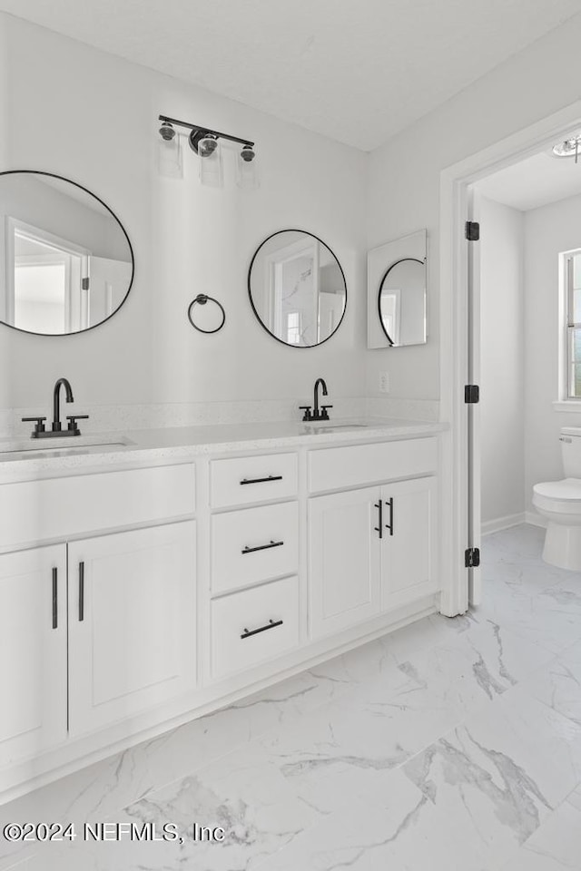 2619 Wrightson Dr, Jacksonville, FL 32223 - full bathroom with double vanity, marble finish floor, and a sink